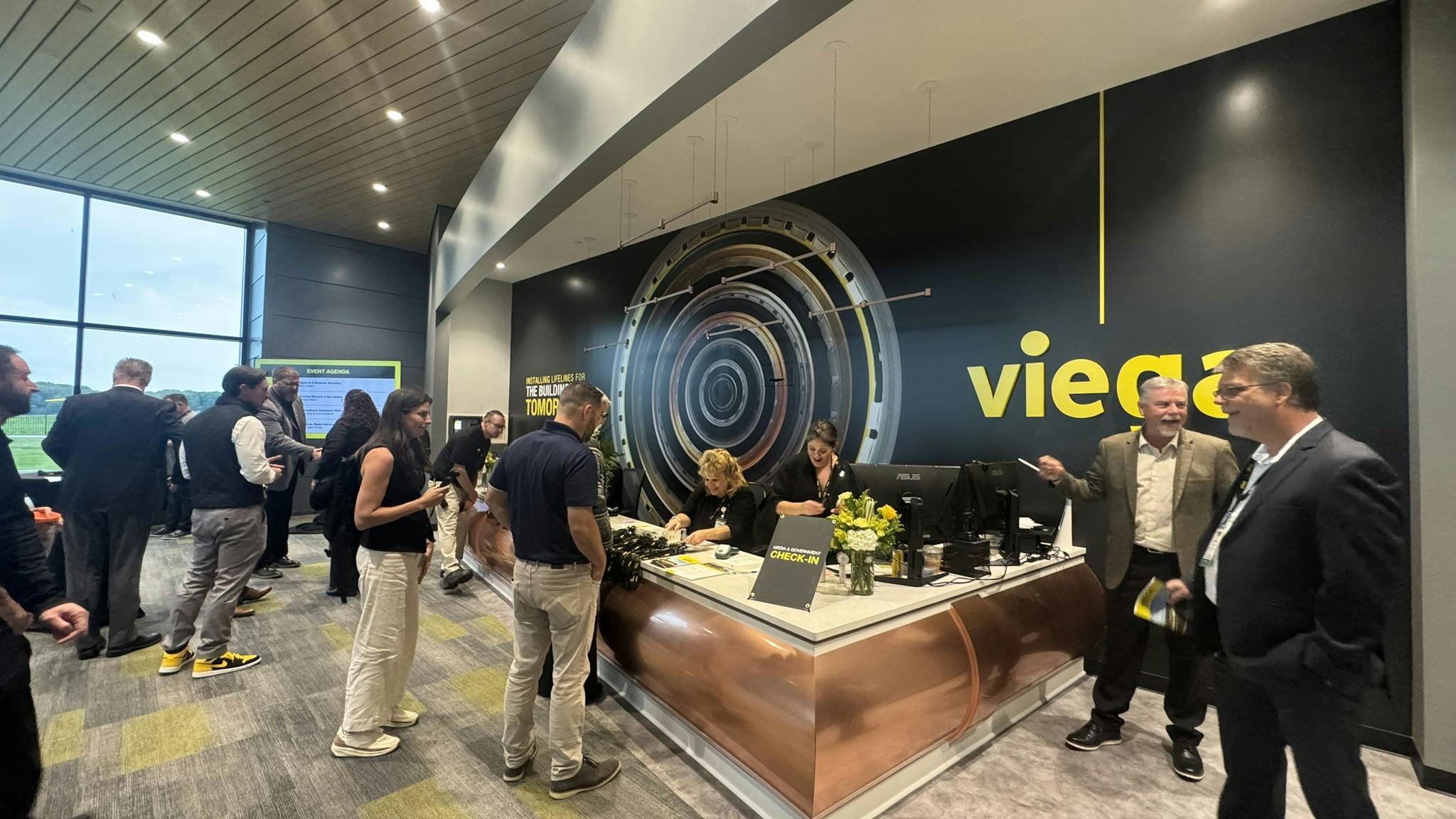 Guests check in at the lobby for the ribbon cutting ceremony of Viega's $178 million new manufacturing and training facility.