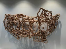 Artist Michael Murphy created an installation transforming Viega ProPress fittings into a floating image of the United States. The piece is located in the new Ohio facility lobby. From head on, you can see the name 'Viega' spelled out. From the right, it forms the state of Ohio. Artist Michael Murphy created an installation transforming Viega ProPress fittings into a floating image of the United States. The piece is located in the new Ohio facility lobby. From head on, you can see the name 'Viega' spelled out. From the right, it forms the state of Ohio.