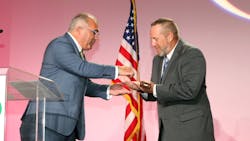 Outgoing IAPMO President Steven Panelli, left, passes the gavel to incoming President Jeremy Stettler during the Installation of Officers Dinner on Sept. 18. Outgoing IAPMO President Steven Panelli, left, passes the gavel to incoming President Jeremy Stettler during the Installation of Officers Dinner on Sept. 18.
