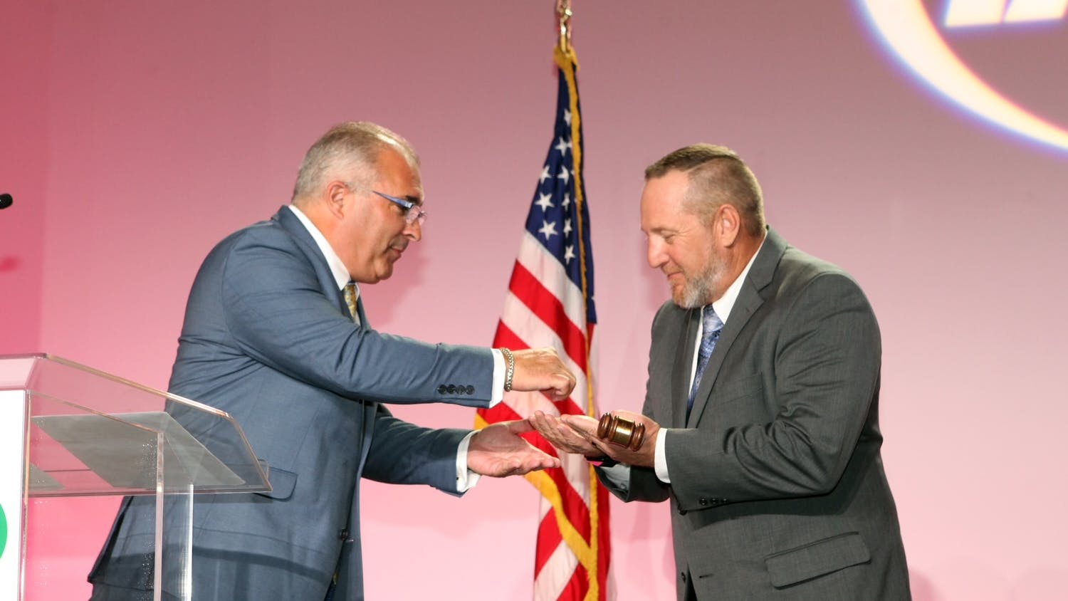Outgoing IAPMO President Steven Panelli, left, passes the gavel to incoming President Jeremy Stettler during the Installation of Officers Dinner on Sept. 18.