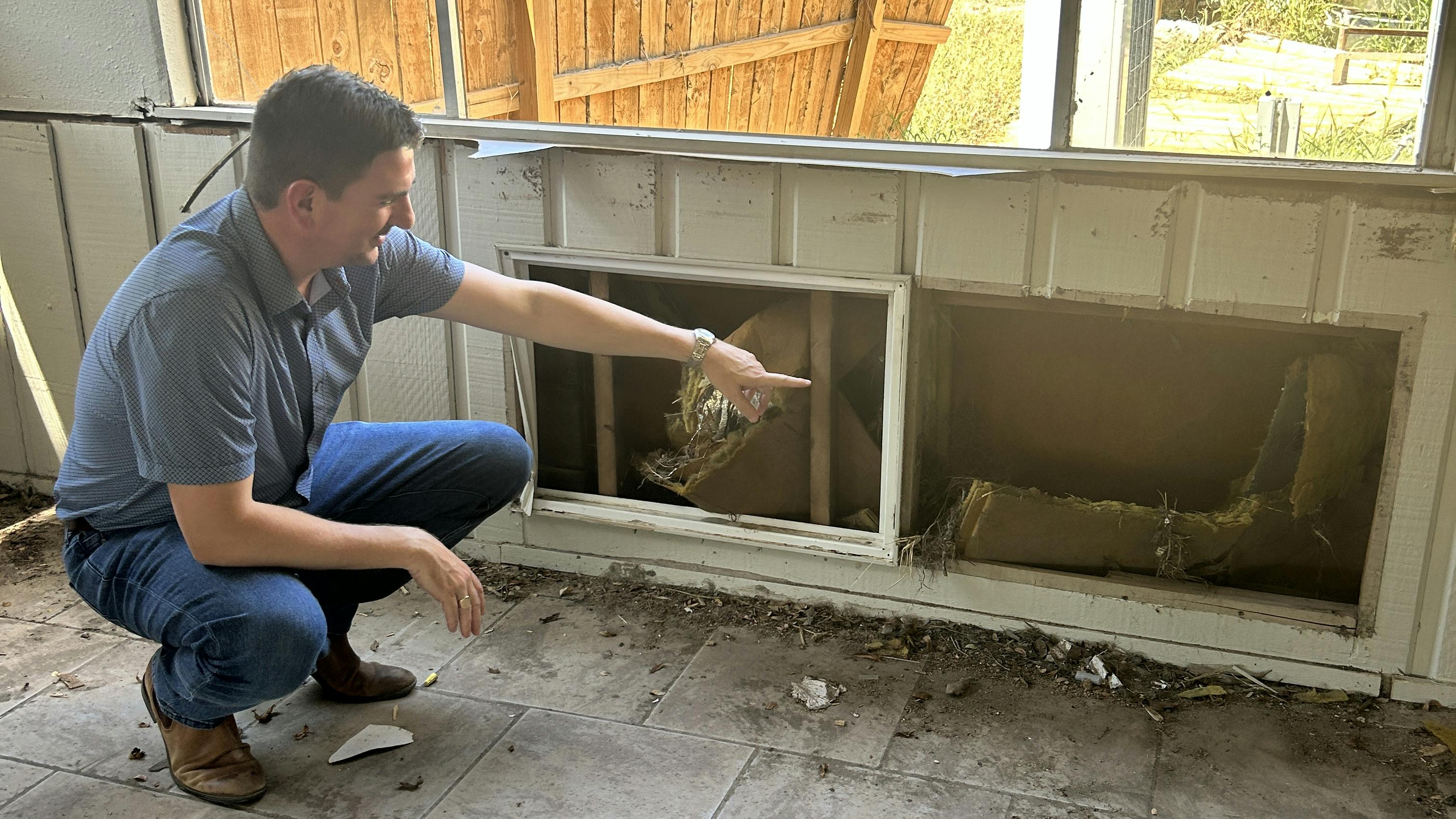 Austin Dickson inspects damage at a local arts nonprofit in Ingram, TX.