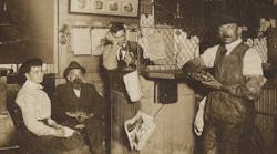 John Bouchard (seated) with employees. John Bouchard (seated) with employees.