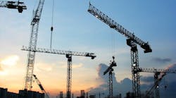 construction cranes at sunset construction cranes at sunset