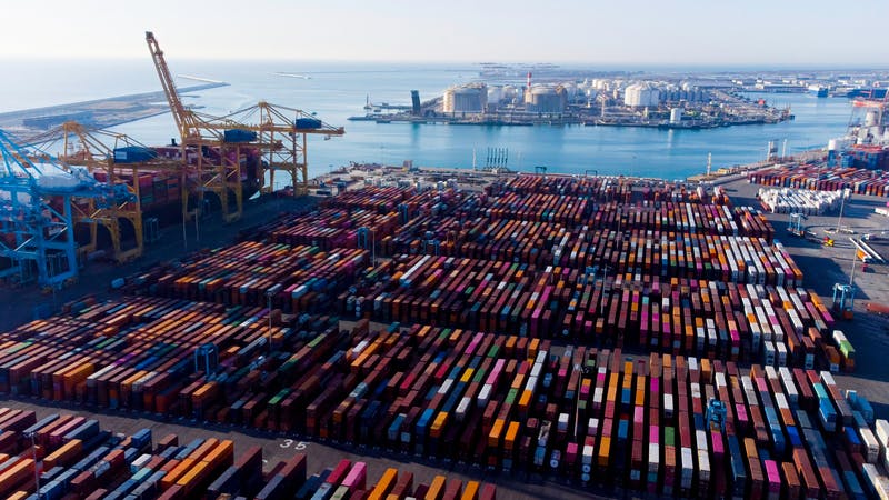 Aerial view of shipping containers and cargo ships in the sea port of Barcelona in Spain, Europe.
