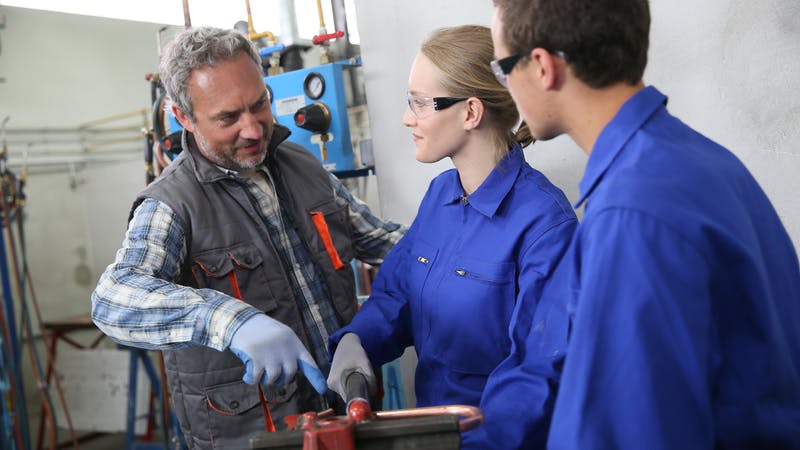 Plumbing students with instructor.