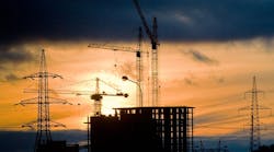 construction cranes at sunset. construction cranes at sunset.