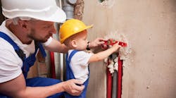 Father and son installing plumbing pipe system at home. Father and son installing plumbing pipe system at home.