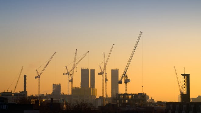 construction cranes at sunrise.