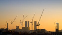 construction cranes at sunrise. construction cranes at sunrise.