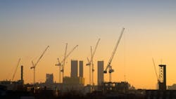 construction cranes at sunrise. construction cranes at sunrise.