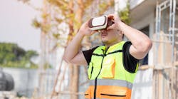 Construction worker using a VR headset on the job site. Construction worker using a VR headset on the job site.