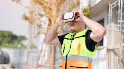 Construction worker using a VR headset on the job site. Construction worker using a VR headset on the job site.