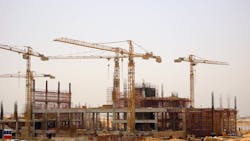 Construction cranes on the job site. Construction cranes on the job site.