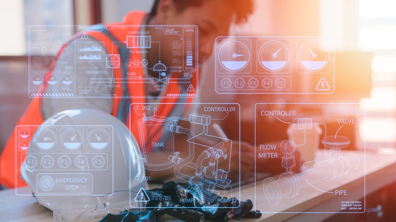 an engineer working on table in site office with hardhat