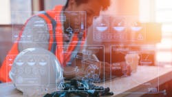 an engineer working on table in site office with hardhat an engineer working on table in site office with hardhat