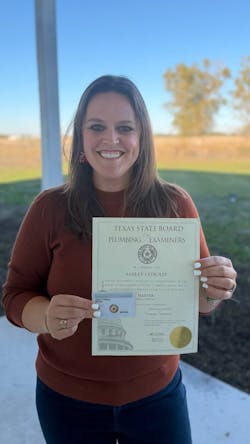 Ashley Stroud proudly displays her plumbing liscence. Ashley Stroud proudly displays her plumbing liscence.