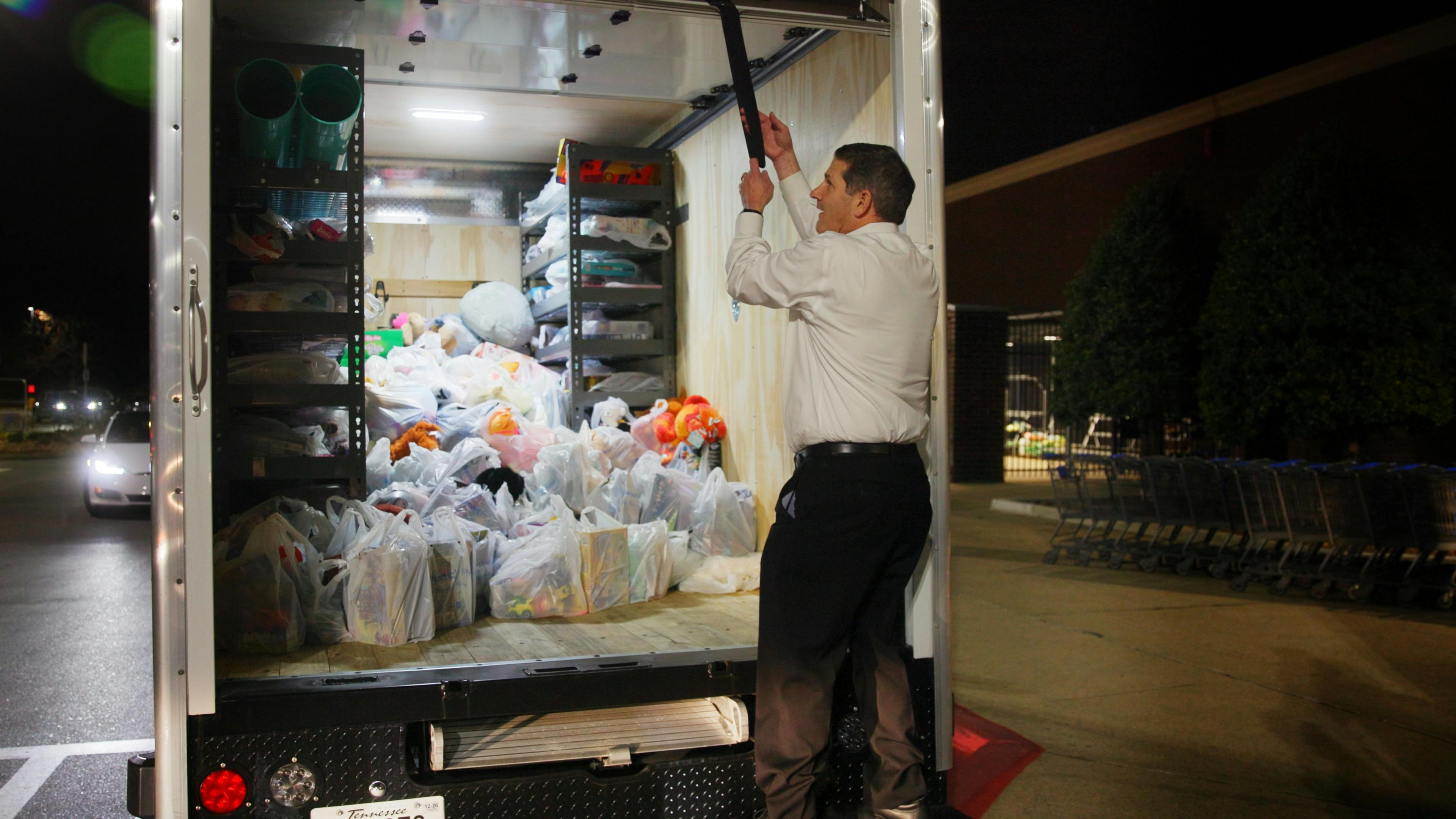 Jimmy Hiller finishes loading toys into a Hiller truck to be delivered to Toys for Tots.