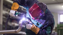 Industrial worker welding in metal factory. Industrial worker welding in metal factory.