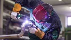 Industrial worker welding in metal factory. Industrial worker welding in metal factory.
