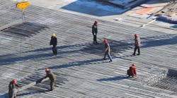 Workers on a construction site. Workers on a construction site.