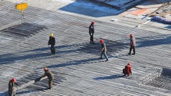 Workers on a construction site. Workers on a construction site.