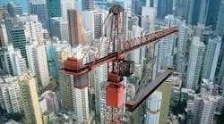View of a construction crane from above looking down onto a metropolitain city scape View of a construction crane from above looking down onto a metropolitain city scape