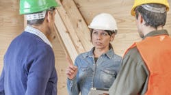 Construction crew listening to female supervisor Construction crew listening to female supervisor