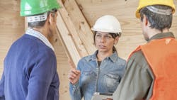 Construction crew listening to female supervisor Construction crew listening to female supervisor