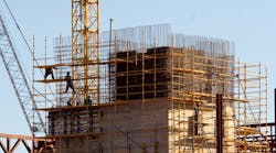 Construction workers climbed on scaffolding. Construction workers climbed on scaffolding.