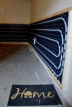 The project integrates hydronic radiant floor heating with existing forced-air furnaces. The project integrates hydronic radiant floor heating with existing forced-air furnaces.