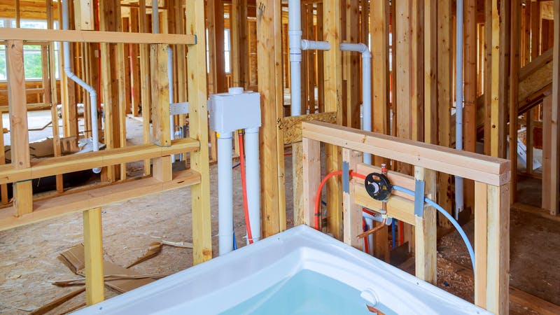 Interior wall framing with piping and bathroom installed
