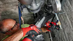 Plumber using a press tool.