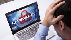 Worried Businessman Looking At Laptop With Ramsomware Worried Businessman Looking At Laptop With Ramsomware