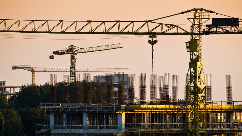 Cranes and construction site at dusk