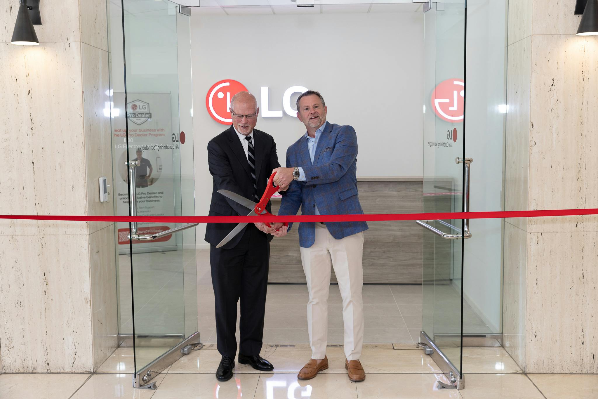 LG Electronics celebrated the grand opening of its new Air Conditioning Technologies Training Academy in Orange, CA, with a ribbon-cutting ceremony attended by Mayor Dan Slater (left) and Steve Scarbrough, senior vice president and general manager of LG Air Conditioning Technologies, LG Electronics USA.