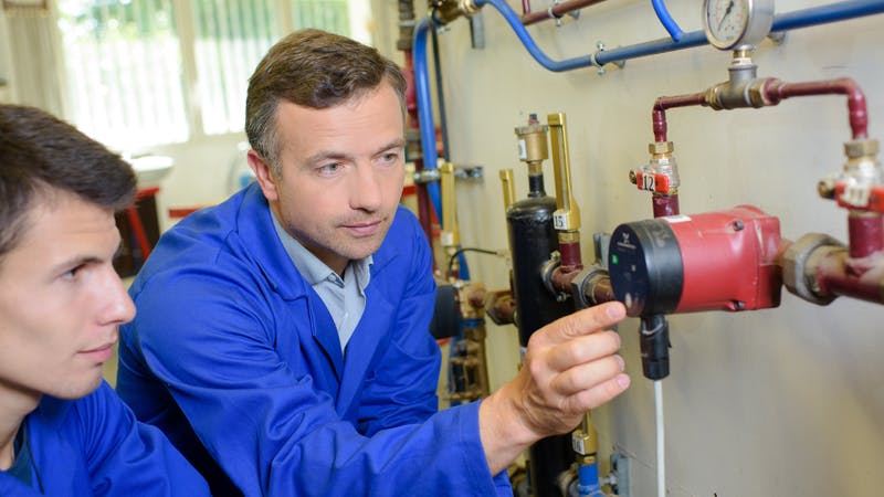 plumber teaching apprentice