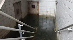 Flooded Basement with Deep Murky Water and Rusty Doors Flooded Basement with Deep Murky Water and Rusty Doors
