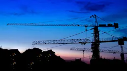 construction cranes at sunset construction cranes at sunset
