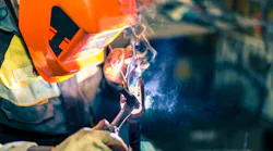 Welder at work in protective gear. Welder at work in protective gear.
