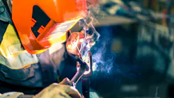 Welder at work in protective gear. Welder at work in protective gear.