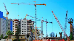 An urban construction site with many cranes An urban construction site with many cranes