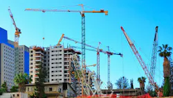 An urban construction site with many cranes An urban construction site with many cranes