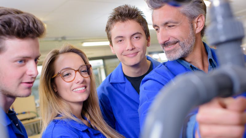 A group of plumbing students with teacher.