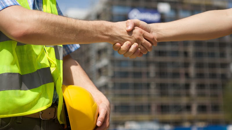 shaking hands at the construction site