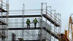 Construction workers in new building of the city Construction workers in new building of the city