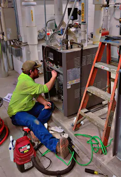 Kaiser Neuhaus working on a boiler. Kaiser Neuhaus working on a boiler.