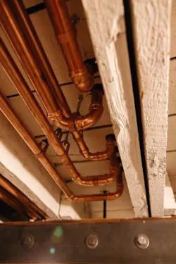 With exposed copper, beams and metal support structure, the basement “man cave” has an industrial revolution feel to it. With exposed copper, beams and metal support structure, the basement “man cave” has an industrial revolution feel to it.