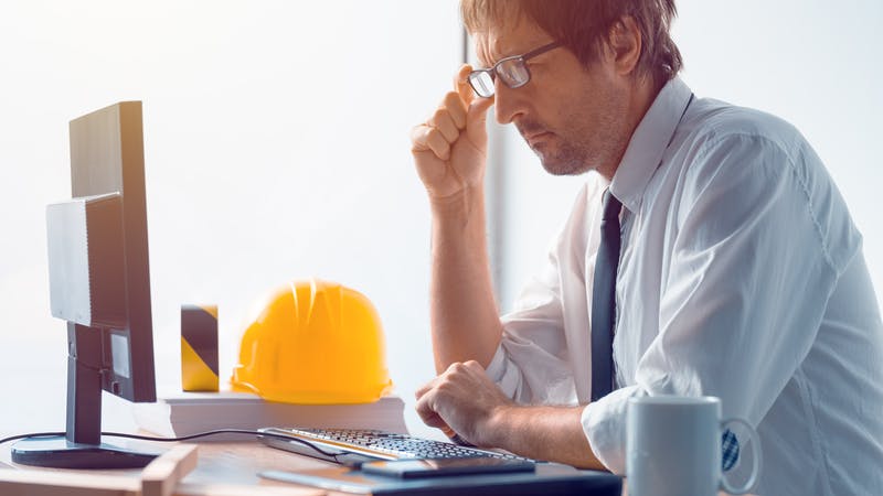 Construction engineer working on desktop computer