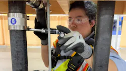 A SkillsUSA contestant installing iron pipe. A SkillsUSA contestant installing iron pipe.