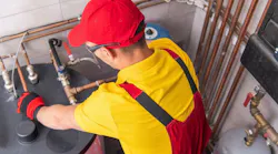 plumber servicing a commercial water heater